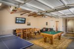The garage has been converted into a game room offering a pool table, ping pong table, Foosball & a large flat screen TV for entertainment.